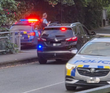 Police at one of the cordons set up on the corner of Nile St and Tory St in central Nelson during...