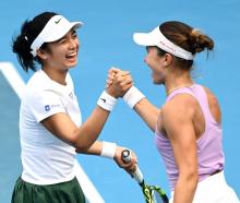 Alexandra Eala (left), of the Philippines, and American Iva Jovic celebrate after winning their...