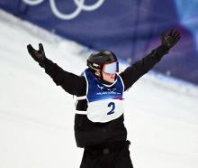 New Zealand’s Zoi Sadowski-Synnott reacts after her second run in the women’s snowboard big air...