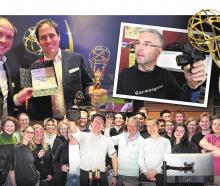 Developer Noel Park holds a previous trophy as Animation Research staff in Dunedin celebrate...