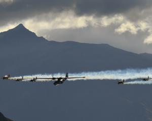 Black Peak dominates the background as the Catalina flying boat, flanked by the RNZAF Black...