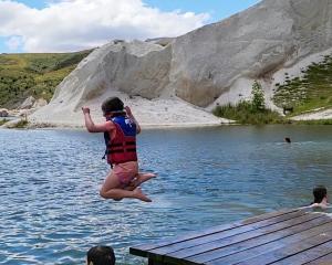 Isabel Armstrong (5) jumps off the jetty at St Bathans’ Blue Lake on Boxing Day, as her brother...