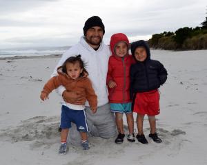  Supporting the wave riders are Curtis Fruean and his children (from left) Bo (1), Wally (5) and...