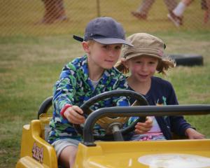Siblings Harry (7) and Ivy (5) Sluis, of Dunedin, do laps in a mini car.