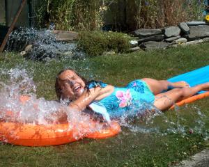 Reve Blair, 9, enjoys a slide and splash at Lake Hawea on December 30. PHOTO: BRIAN MILLER