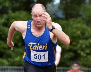 Local athlete Paul Davies, of Taieri, takes off in the 100m sprint.