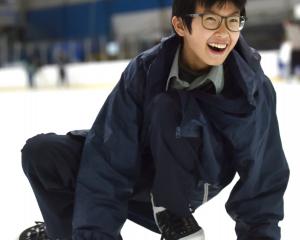 Zev Bai, 14, of China, a year 10 pupil at Bayfield High School, has a laugh as he lowers his...