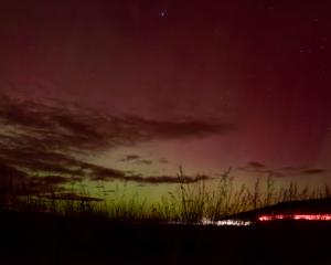 Aurora Australis over Matakaea/Shag Point on Saturday night, with the tail lights of a car...