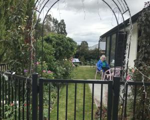 A welcoming archway which frames Sherryn Bryan sitting in her garden. PHOTOS: GILLIAN VINE