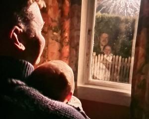 Sparking joy ... Darren and Gus, 6, Stasso watch the New Year’s Eve fireworks in Pounawea. PHOTO:...