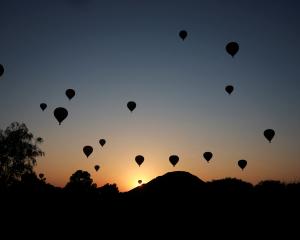 Hot air balloons float near the Pyramid of the Sun, following the spring equinox, in the pre...