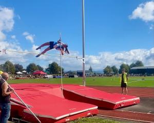 Queen’s High School’s Martha Lipross competes in the pole vault at the SISS Athletics competition...