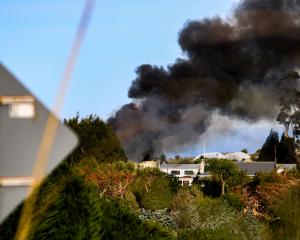 A dark plume of smoke rises from the fire on Tuesday. Photo: Angelus Parker