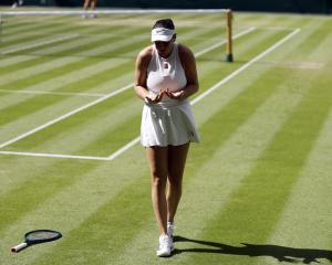 Amanda Anisimova, of the United States, reacts during her winning semifinal match against Belarus...