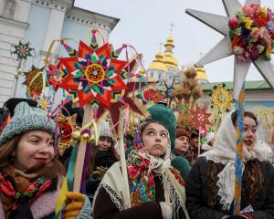People dressed in traditional Ukrainian costumes attend Christmas celebrations in Kyiv yesterday....