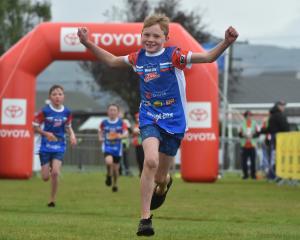 Oscar Jeffries, of Maniototo, crosses the finish line in yesterday’s WeetBix Kiwi Kids TRYathlon...