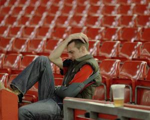 A Welsh rugby fan is disconsolate after watching the game on big screens at the Millenium Stadium...