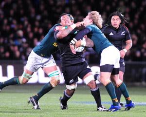 All Black replacement No 8 Sione Lauaki is collared in a high tackle by Springbok lock Victor...