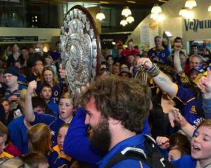 A bemused Liam Coltman looks on as the shield moves through the crowd.