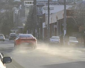 A car throws up a cloud of dust in Albany St, Dunedin, where airborne dirt and soil particles...