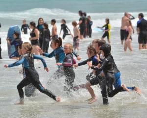 A class of ''Nippers'' from the St Clair Surf Life Saving Club join swimmers at St Clair Beach on...