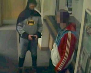 A man dressed as Batman and a burglary suspect stand in a police station in Bradford, northern...