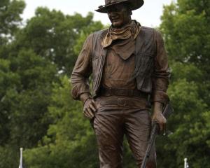 A statue of John Wayne, donated by his children, stands on the site in Winterset, Iowa, where a...