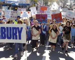About 1000 people protest against the closure of Forbury School during a march on George St,...
