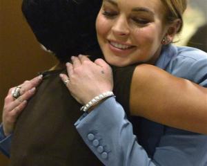 Actress Lindsay Lohan hugs her attorney Shawn Holley in this March file photo. REUTERS/Joe Klamar...
