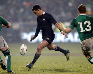 All Black first five Dan Carter kicks a drop goal during the second test against Ireland in...