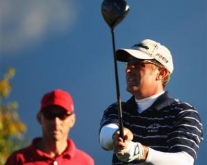 American Jeff Gove (right) watches the ball after teeing off on the eight hole on the second day...