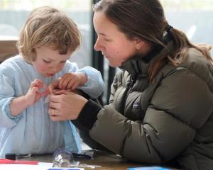 Amy Thorburn helps daughter Audrey (2) make a miniature steamship at the Swashbuckling Steamships...