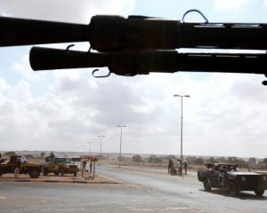 Anti-Gaddafi fighters man a checkpoint approximately 2km from the centre of Sirte. Photo: REUTERS...