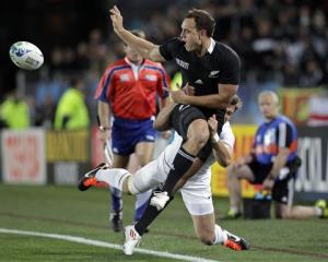 Israel Dagg passes the ball as he is tackled by France's Alexis Palisson. (AP Photo/Themba Hadebe)