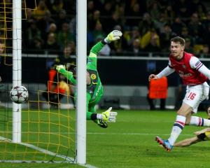 Arsenal's Aaron Ramsey (R) scores past Borussia Dortmund's goalkeeper Roman Weidenfeller. REUTERS...