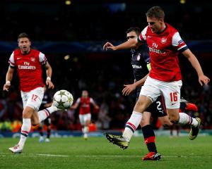 Arsenal's Aaron Ramsey scores a goal against Olympiakos Piraeus during their Champions League...