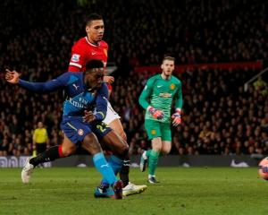 Arsenal's Danny Welbeck shoots to score against Manchester United. Action Images via Reuters /...