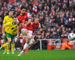 Arsenal's Mikel Arteta shoots to score against Norwich City during their English Premier League...