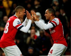 Arsenal's Theo Walcott (R) celebrates his third goal against Newcastle United with Kieran Gibbs...