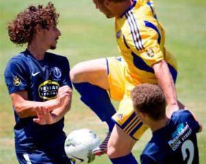 Auckland City FC's Albert Riera (left) and Simon Arms clash with Otago United's Victor Da Costa...