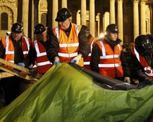Bailiffs remove tents from the Occupy encampment in front of St Paul's Cathedral in London early...