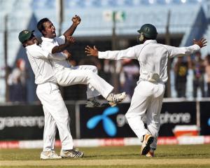 Bangladesh players, from left, Shahriar Nafees, Elias Sunny and Raqibul Hasan celebrate the...