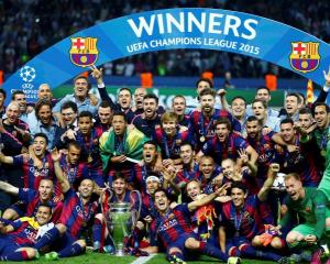 Barcelona players celebrate with the trophy after winning the Champions League final. Photo:...