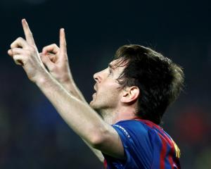 Barcelona's Lionel Messi celebrates scoring his second penalty against AC Milan during their...