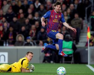 Barcelona's Lionel Messi (R) scores his fourth goal past Bayer Leverkusen's goalkeeper Bernd Leno...