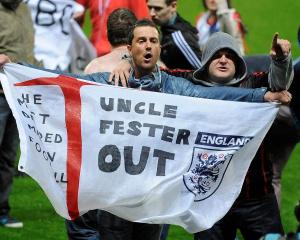 Blackburn Rovers fans protest on the pitch after their team lost to Wigan Athletic in their...