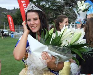 Blossom Festival Queen Ellie Trask (18) takes a congratulatory call after the crowning ceremony....