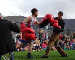 Boxing busker and professional clown Fraser Hooper (left), of Wellington, takes on Wanaka man...