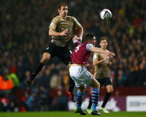 Bradford City's James Hanson (L) jumps above Aston Villa's Ciaran Clark during their English...