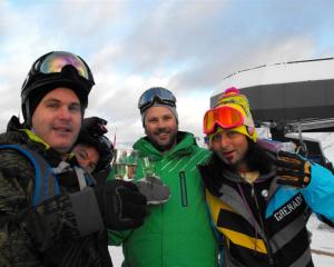 Brendon Cameron, Karl Hunt and Eddy Lecotey, all of Queenstown, make the most of the free bubbly...